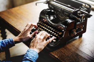 negative-space-vintage-desk-typewriter-man-hands-rawpixel-thumb-1